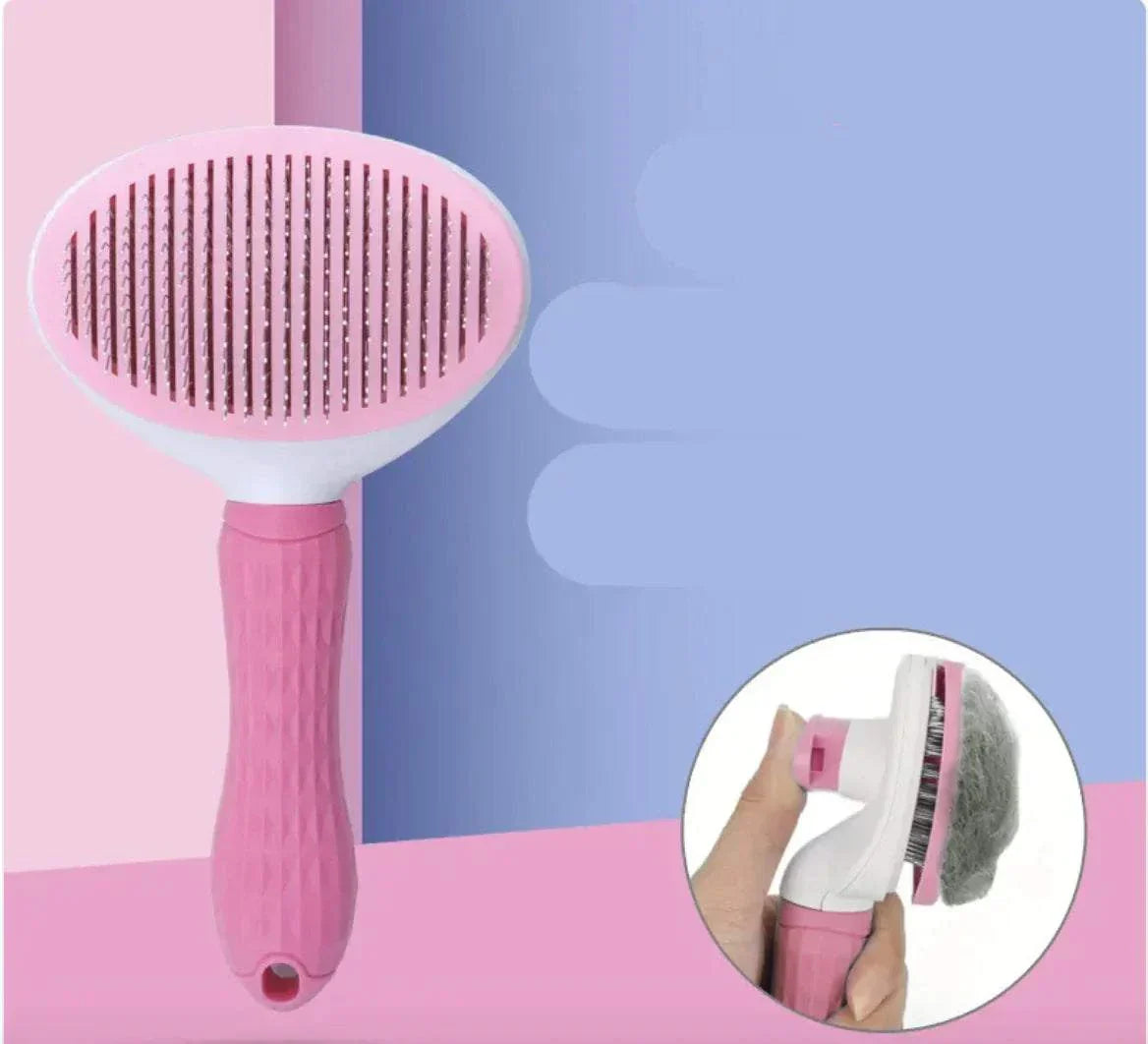 Pink pet hair removal comb with ergonomic handle and round head design for cats and dogs.