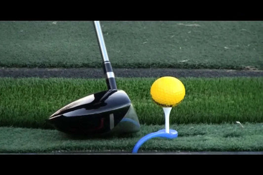 Golf club and ball on tee with NeverLostGolf Tee Saver ™ on grass.